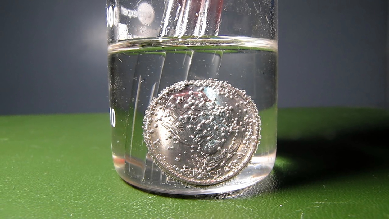 Hydrochloric acid and Ukrainian 2 hryvnias coin.      2 