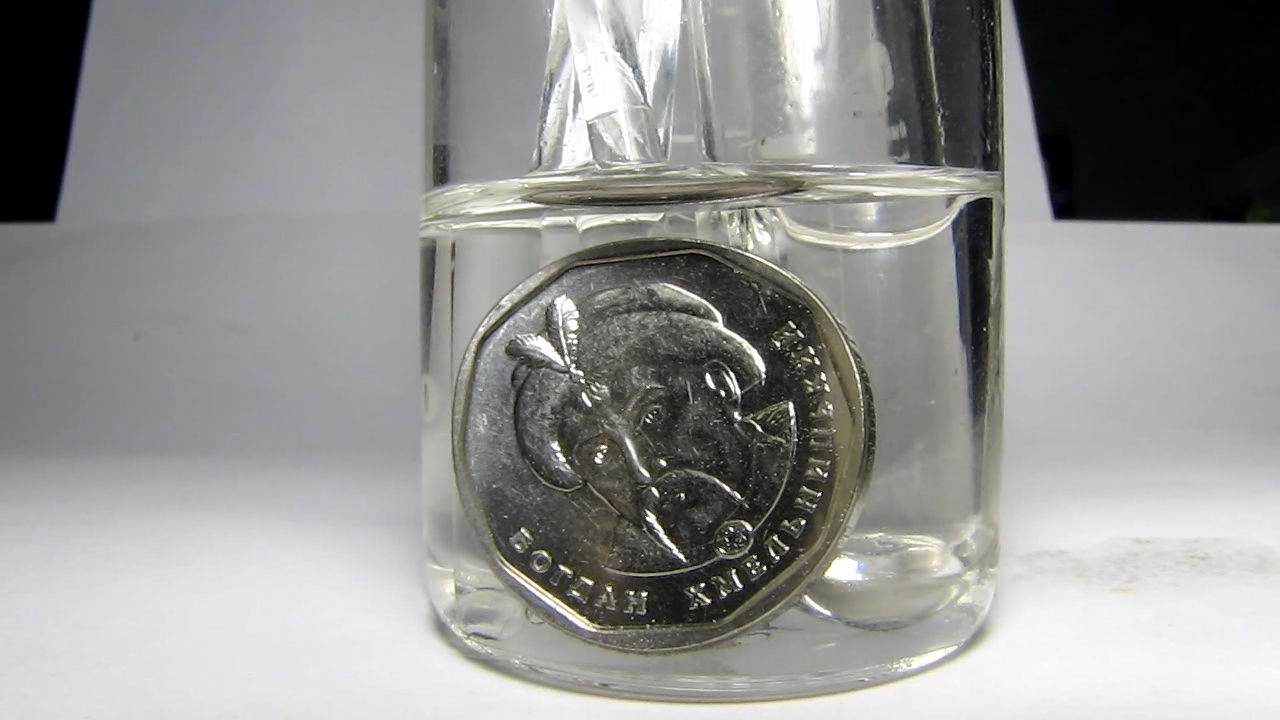 Hydrochloric acid and Ukrainian 5 hryvnias coin.      5 