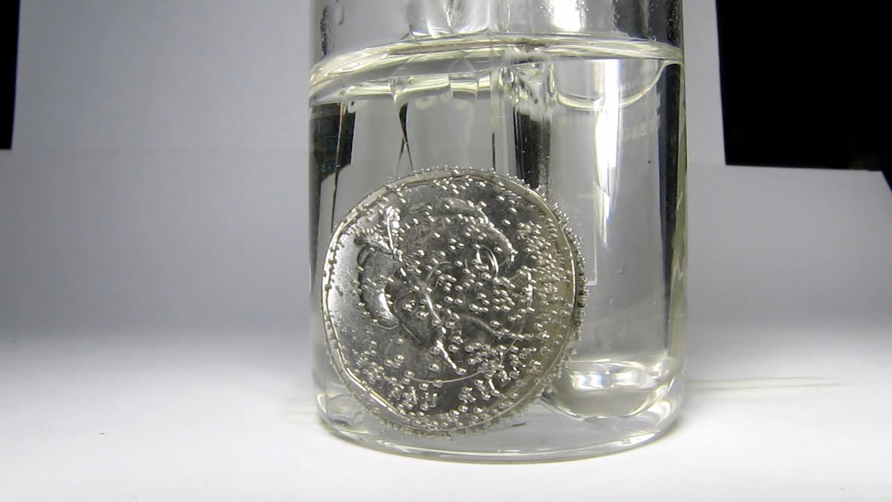 Hydrochloric acid and Ukrainian 5 hryvnias coin.      5 