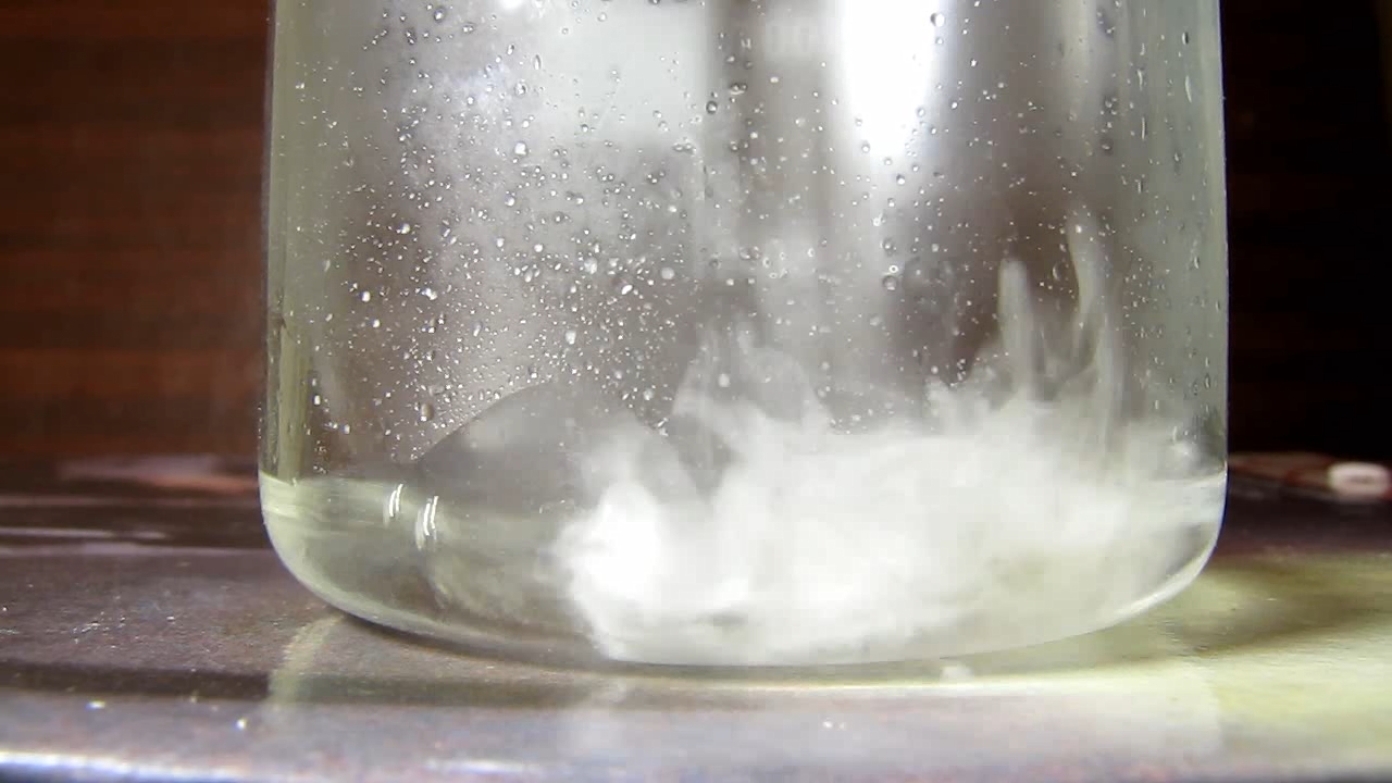 Reaction of concentrated nitric acid and solid potassium hydroxide.        