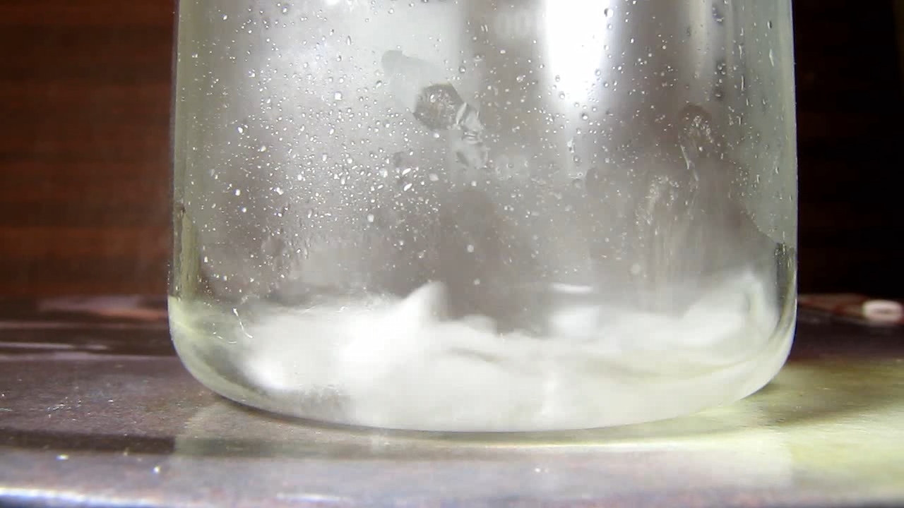 Reaction of concentrated nitric acid and solid potassium hydroxide.        