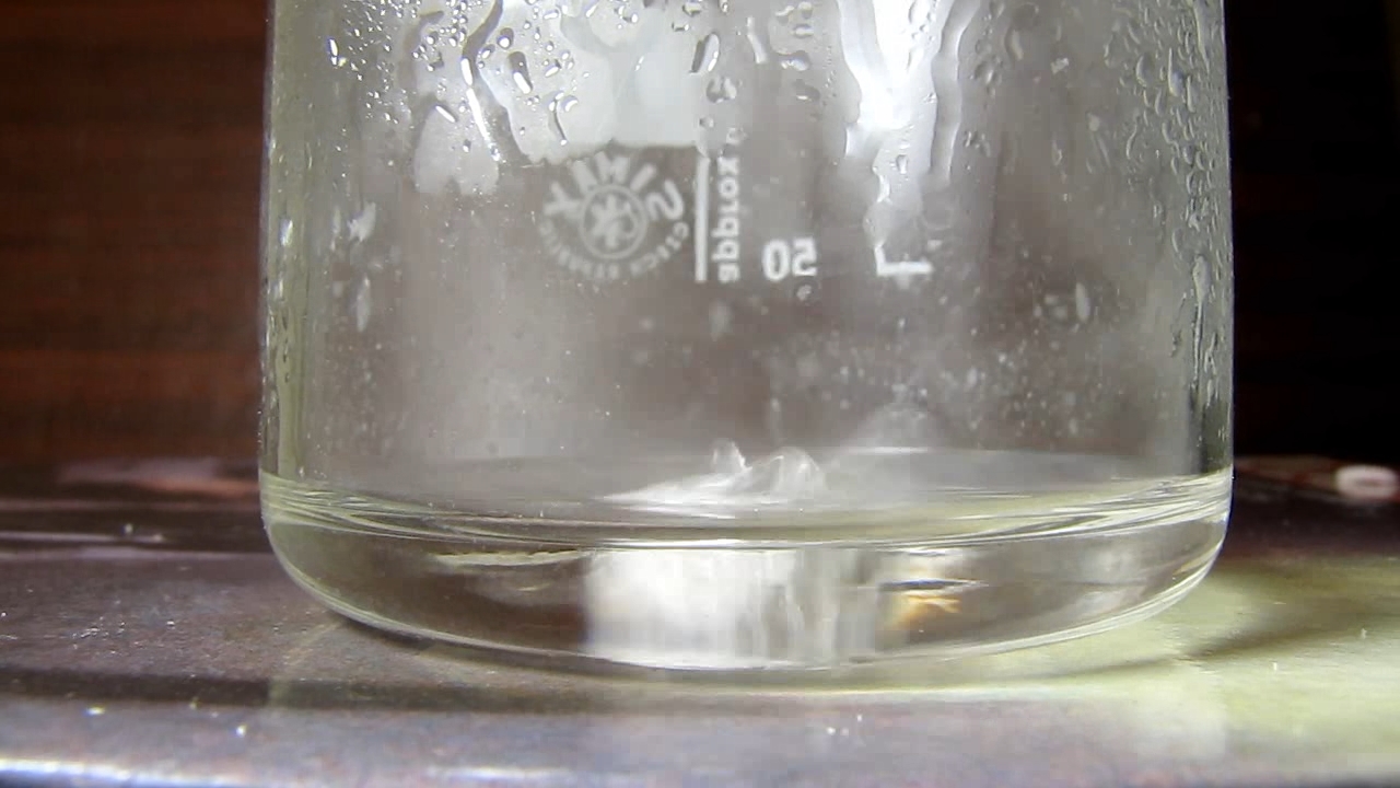 Reaction of concentrated nitric acid and solid potassium hydroxide.        