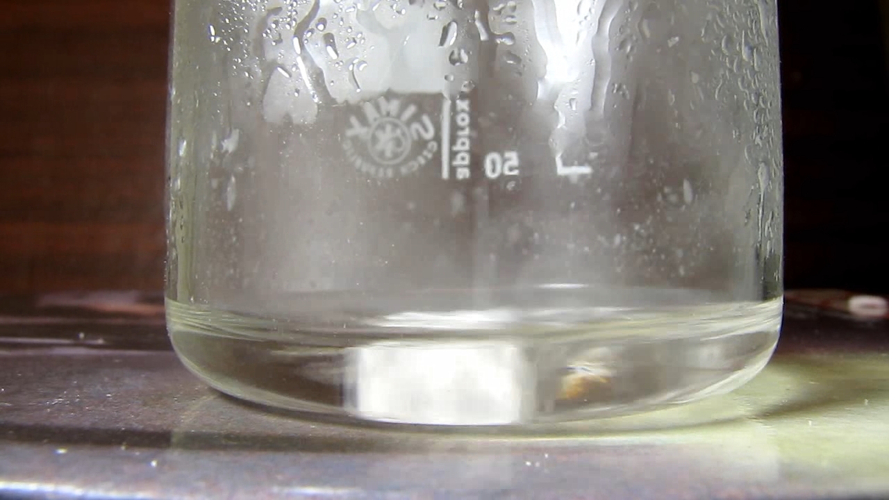 Reaction of concentrated nitric acid and solid potassium hydroxide.        