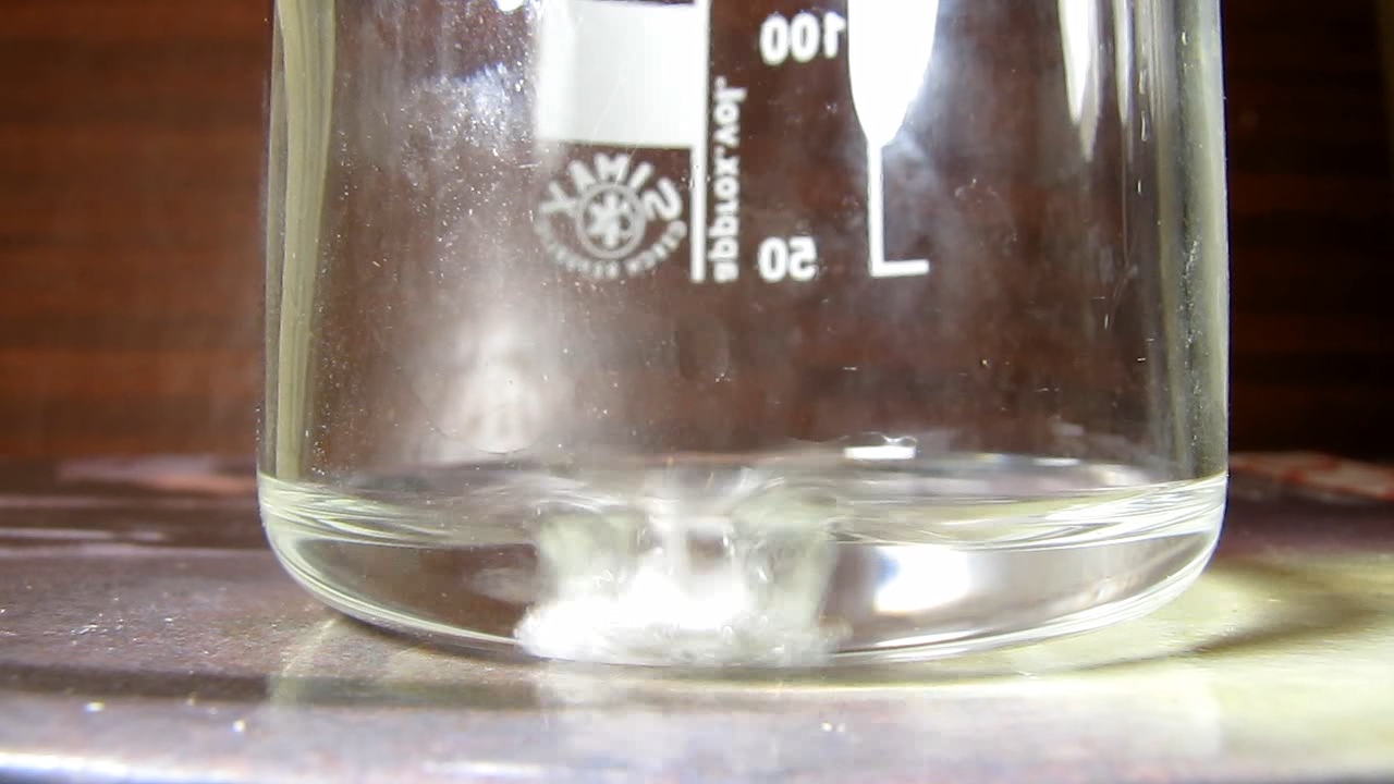 Reaction of concentrated nitric acid and solid potassium hydroxide.        