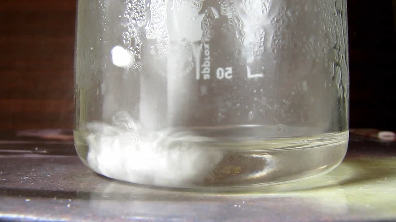 Reaction of concentrated nitric acid and solid potassium hydroxide.        