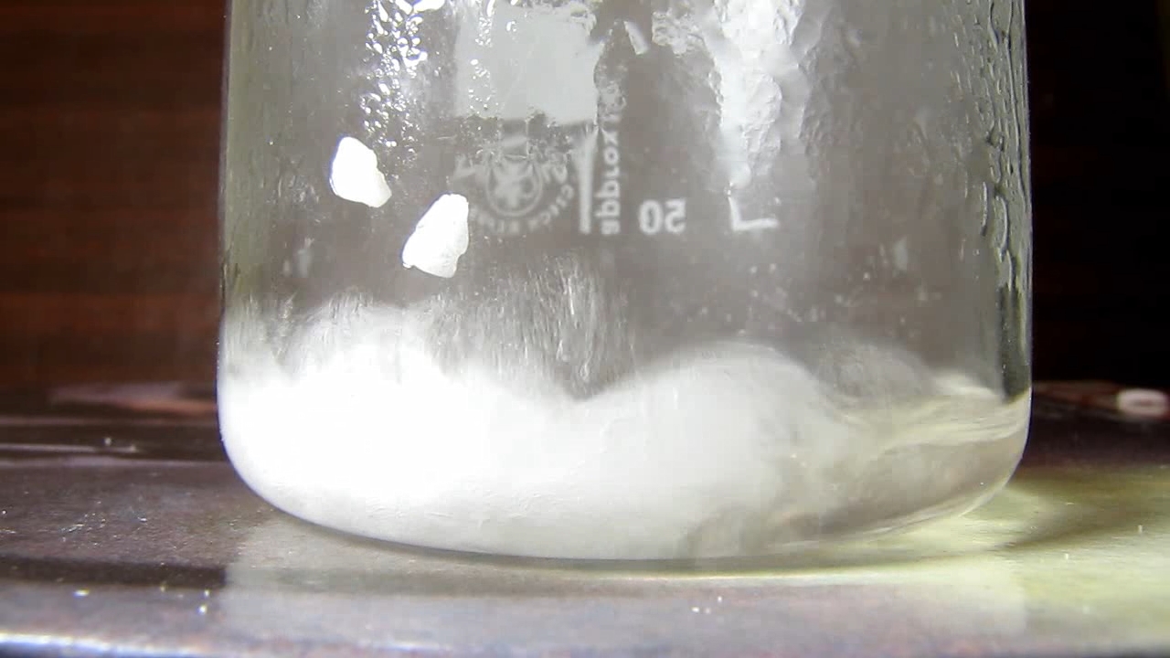 Reaction of concentrated nitric acid and solid potassium hydroxide.        