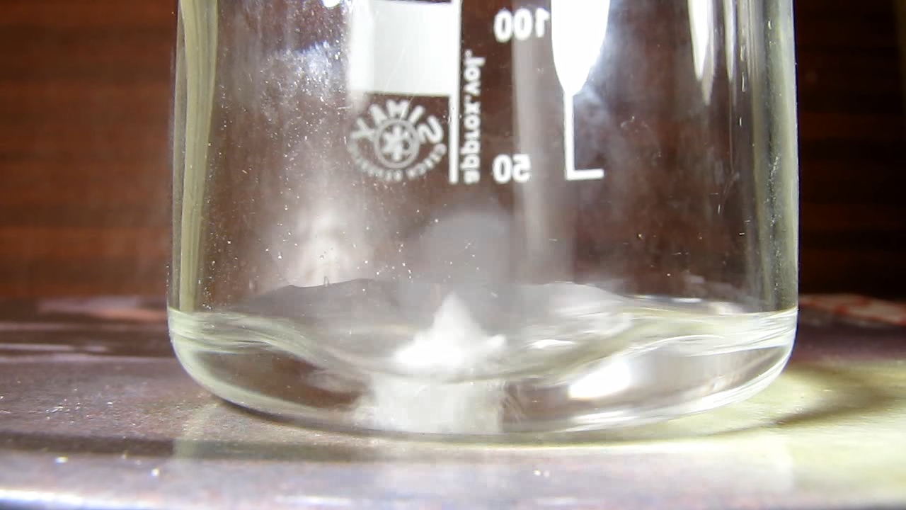 Reaction of concentrated nitric acid and solid potassium hydroxide.        