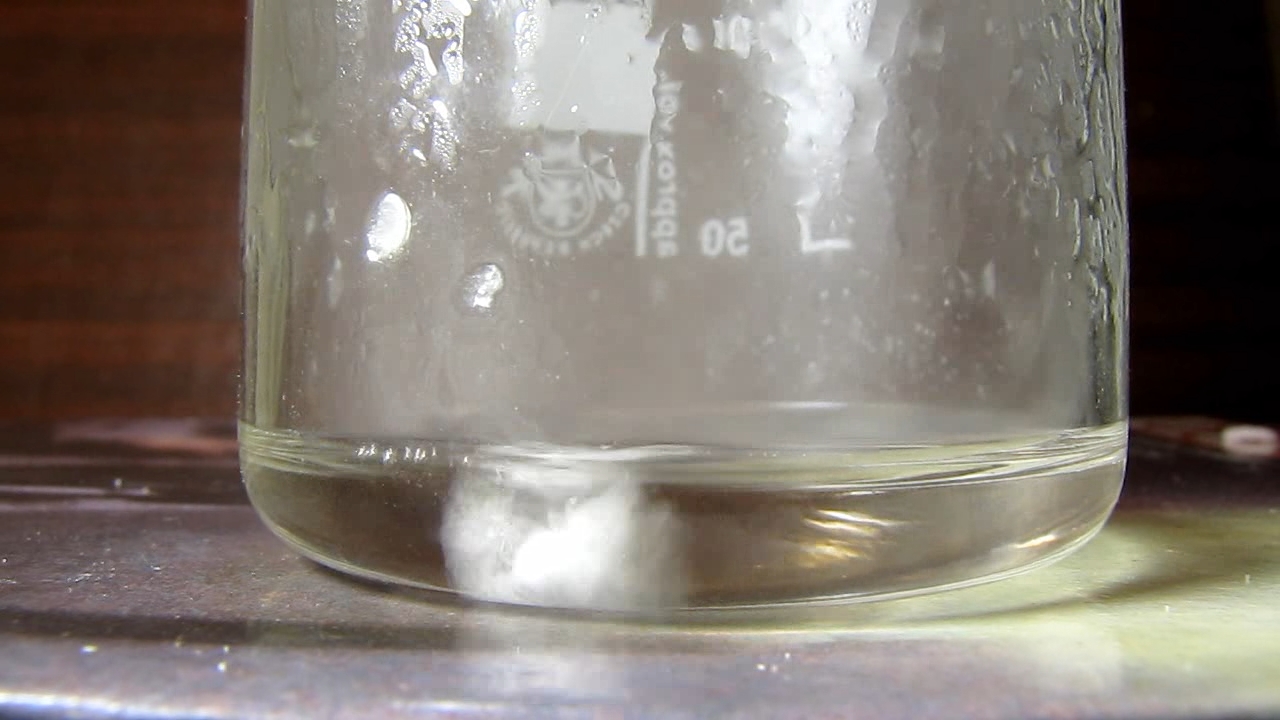 Reaction of concentrated nitric acid and solid potassium hydroxide.        