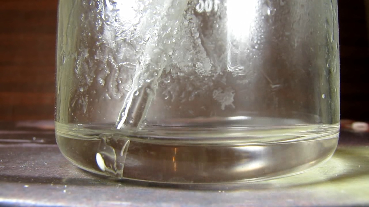 Reaction of concentrated nitric acid and solid potassium hydroxide.        