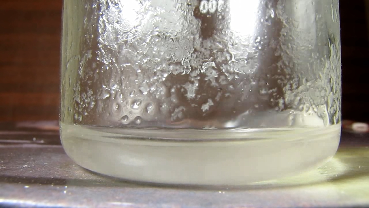 Reaction of concentrated nitric acid and solid potassium hydroxide.        