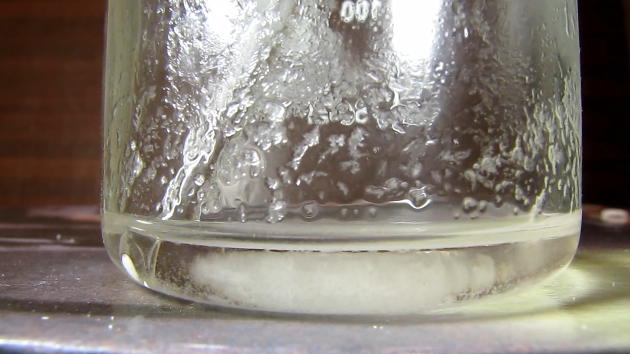 Reaction of concentrated nitric acid and solid potassium hydroxide.        