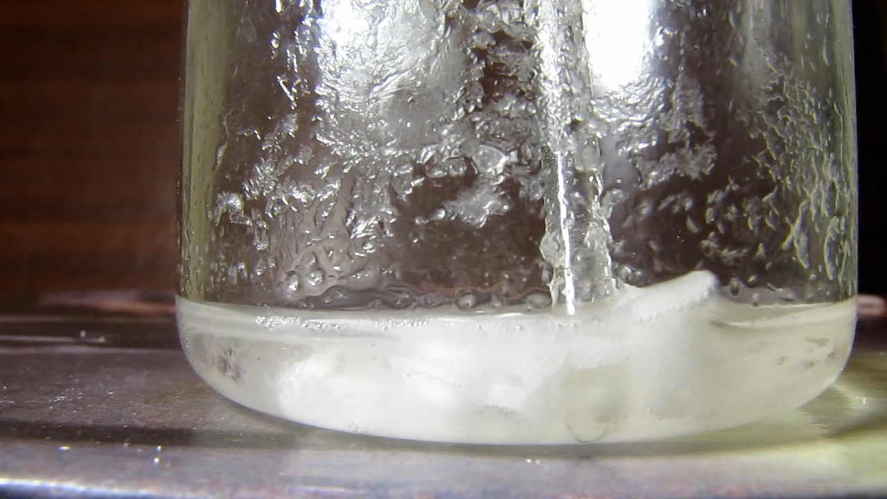 Reaction of concentrated nitric acid and solid potassium hydroxide.        