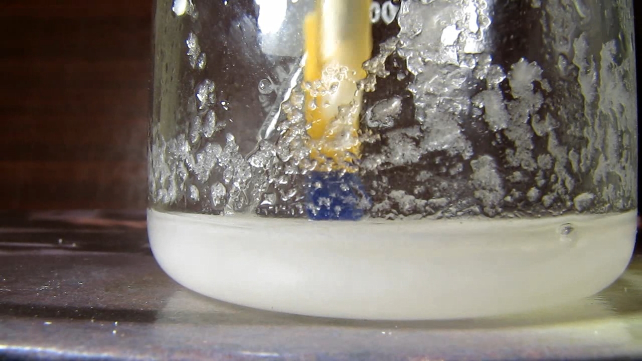 Reaction of concentrated nitric acid and solid potassium hydroxide.        