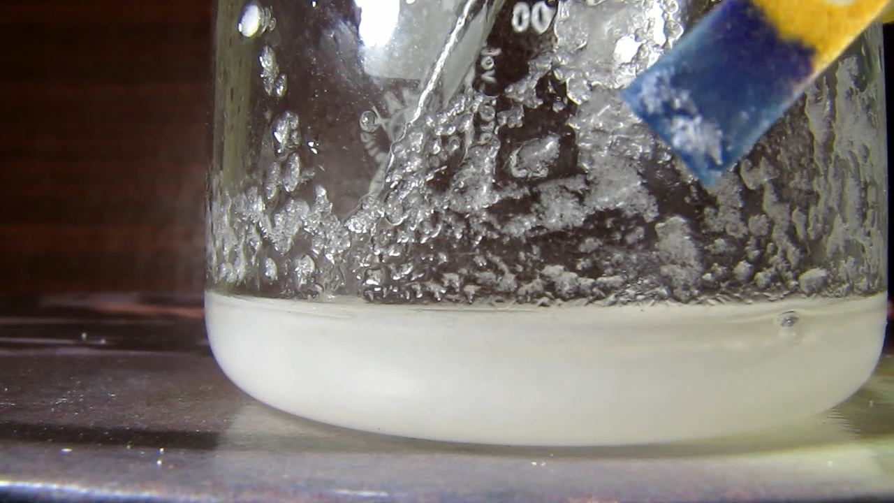 Reaction of concentrated nitric acid and solid potassium hydroxide.        