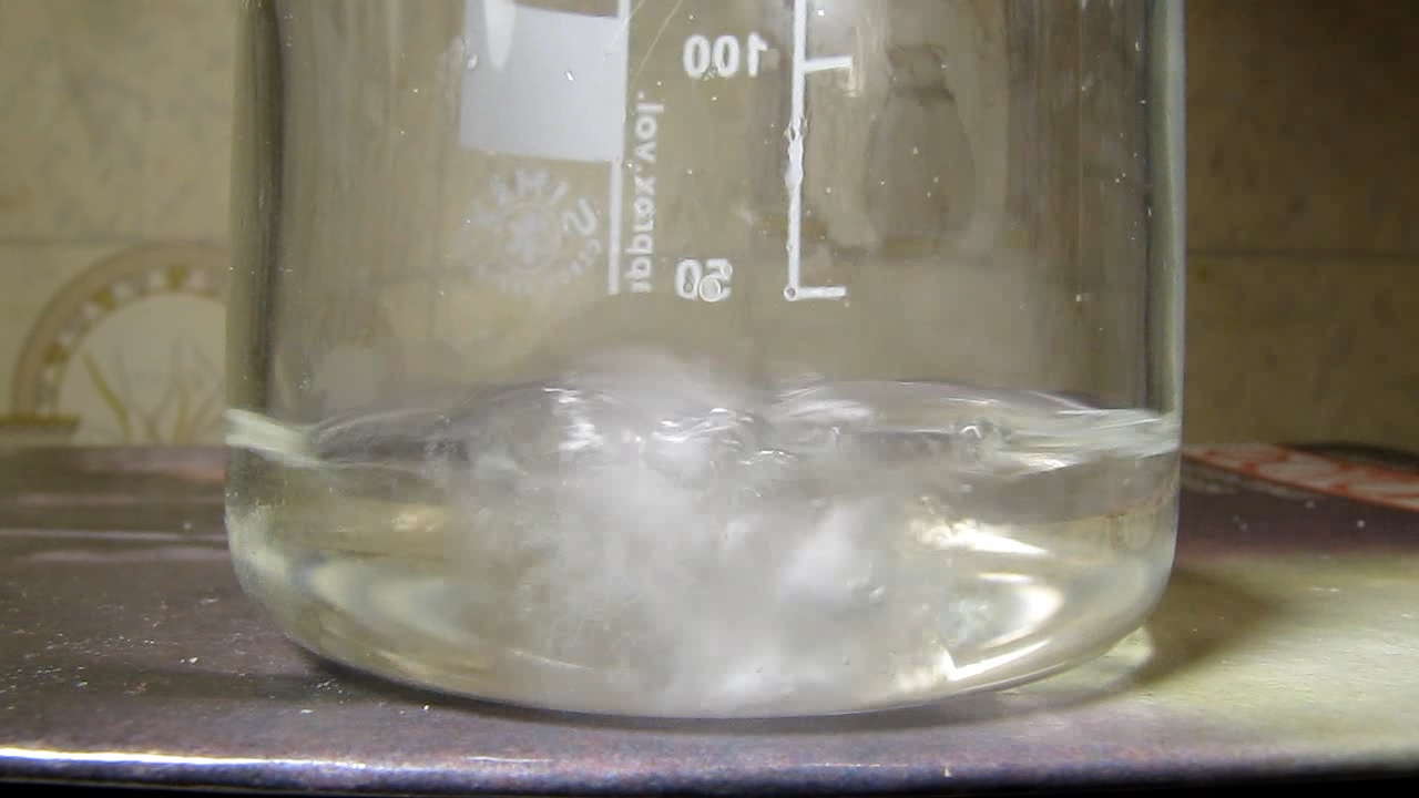 Reaction of concentrated nitric acid and solid potassium hydroxide.        