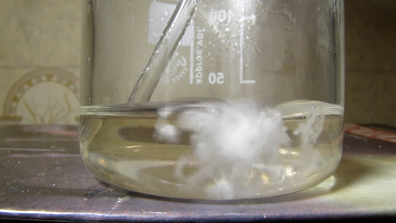 Reaction of concentrated nitric acid and solid potassium hydroxide.        