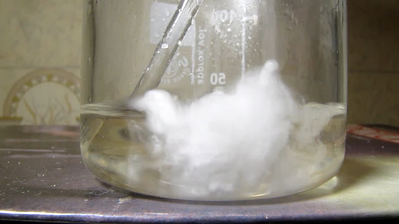 Reaction of concentrated nitric acid and solid potassium hydroxide.        