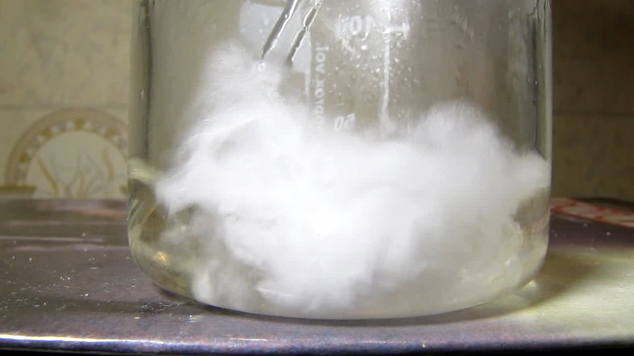 Reaction of concentrated nitric acid and solid potassium hydroxide.        