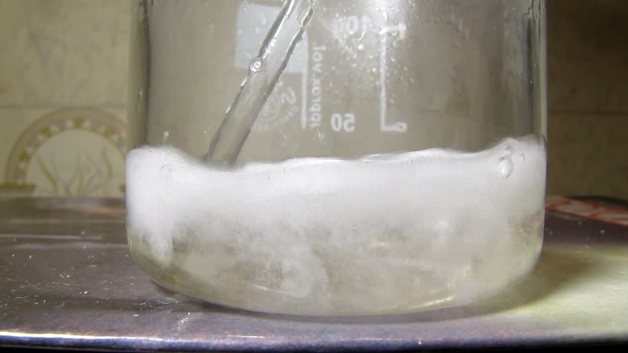 Reaction of concentrated nitric acid and solid potassium hydroxide.        