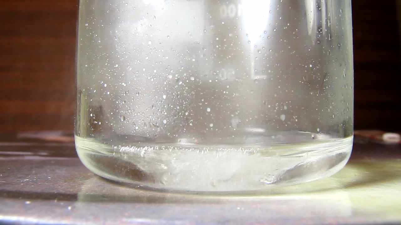 Reaction of concentrated nitric acid and solid potassium hydroxide.        