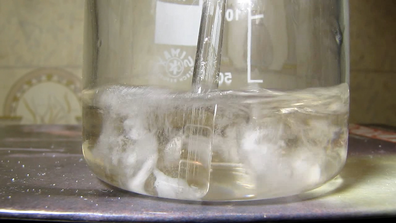 Reaction of concentrated nitric acid and solid potassium hydroxide.        