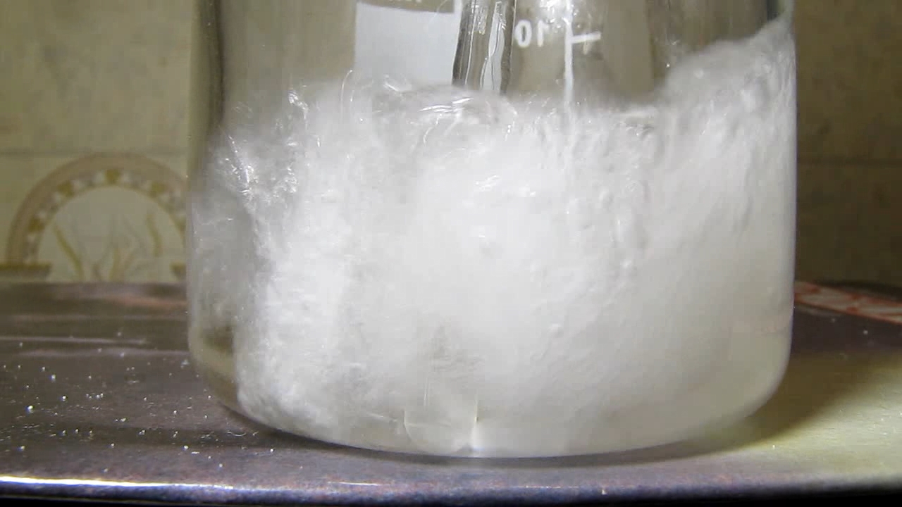 Reaction of concentrated nitric acid and solid potassium hydroxide.        