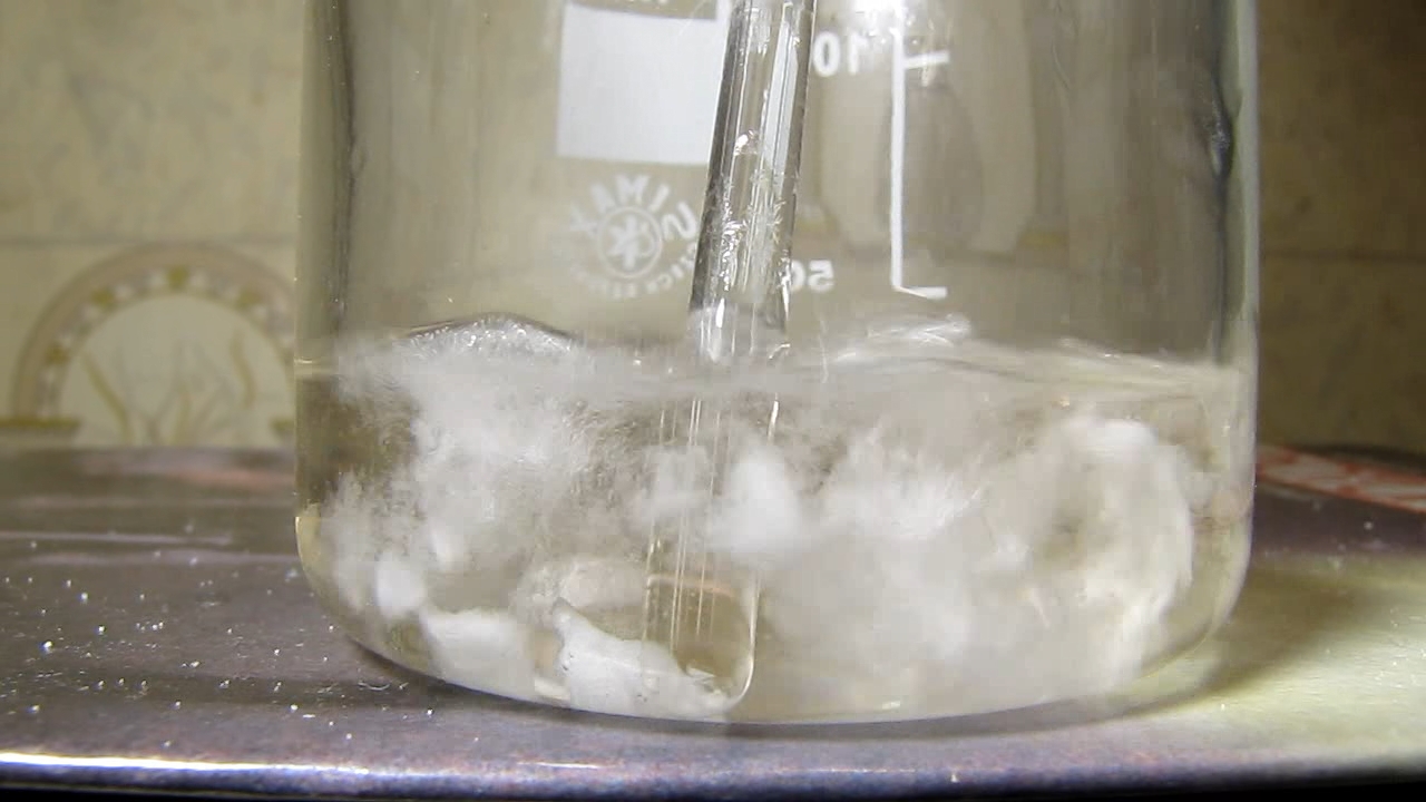 Reaction of concentrated nitric acid and solid potassium hydroxide.        