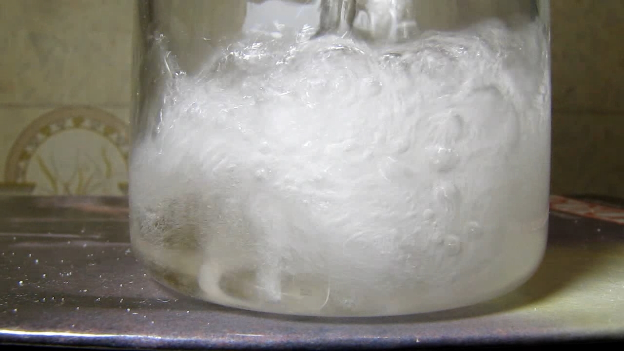 Reaction of concentrated nitric acid and solid potassium hydroxide.        