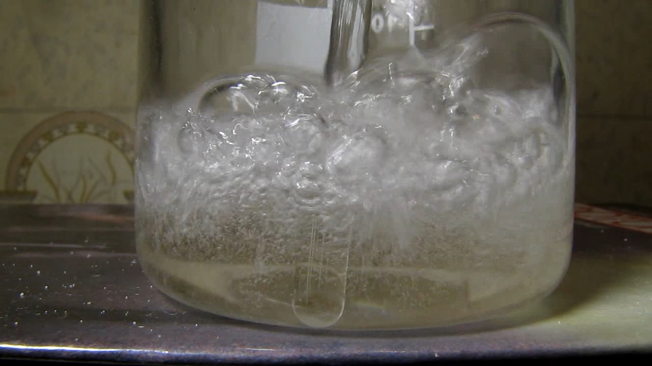 Reaction of concentrated nitric acid and solid potassium hydroxide.        