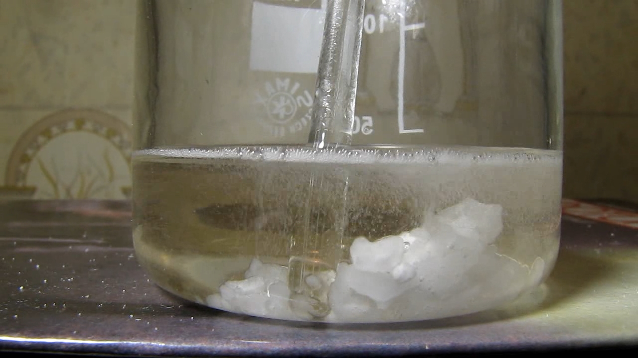 Reaction of concentrated nitric acid and solid potassium hydroxide.        